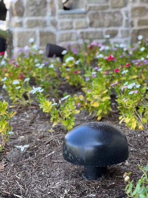 Outdoor landscape subwoofer installed in garden bed