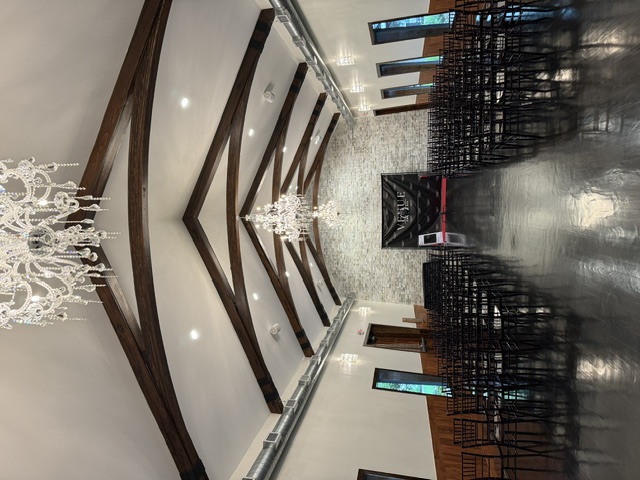 Commercial event venue with AV installation, chandeliers and exposed beams