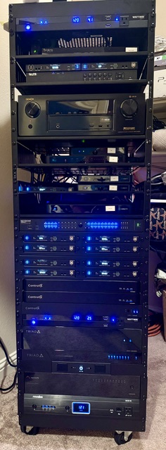 Large full-height AV equipment rack with blue LED lighting