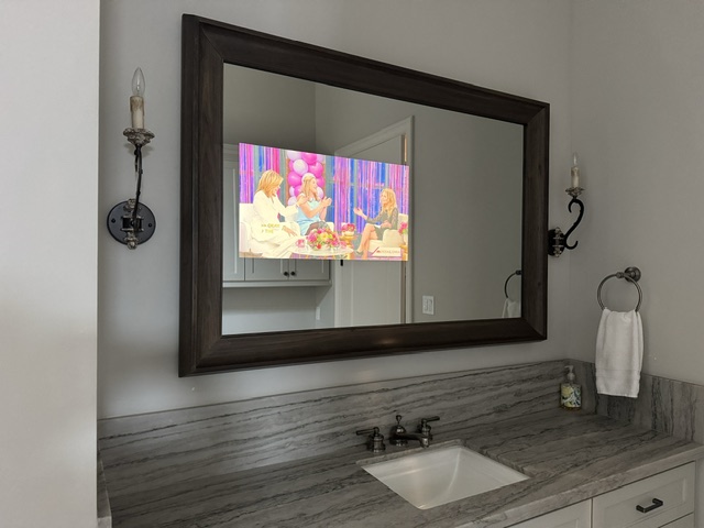 Mirror TV installed in master bathroom vanity mirror