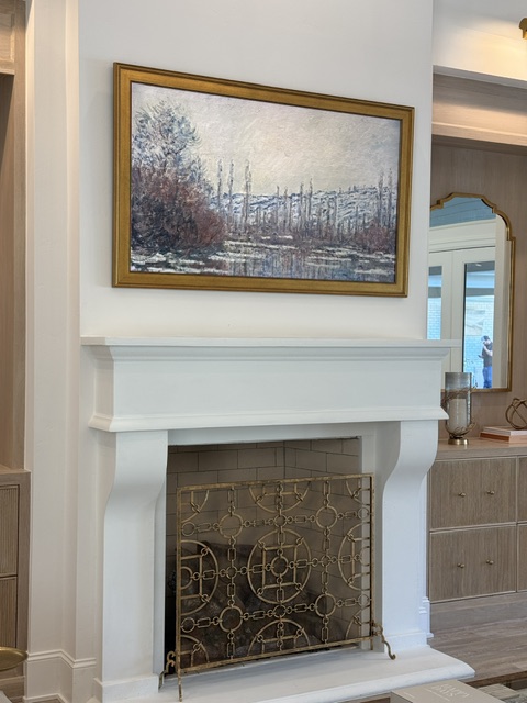Samsung Frame TV displaying artwork above fireplace mantel