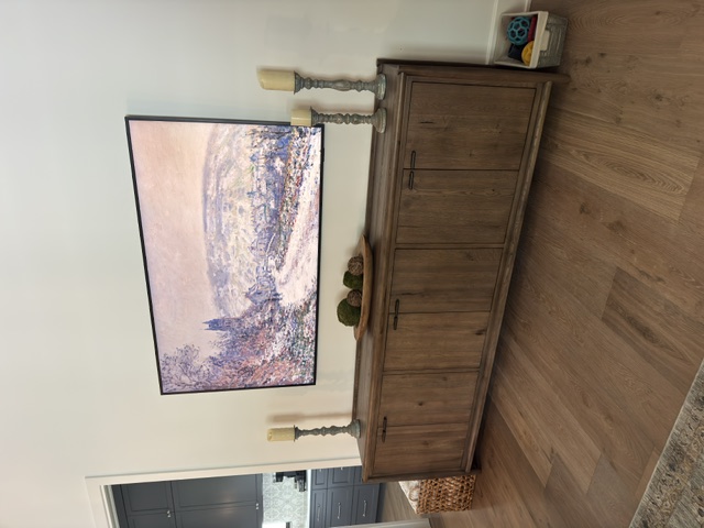 Large Samsung Frame TV in living room displaying artwork